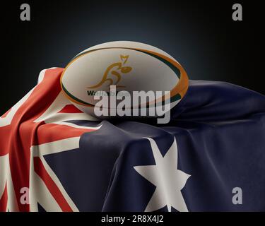 Eine 3D-Darstellung eines generischen Rugby-Balls mit dem Rugby-Logo der Wallabys, das auf einer drapierten australischen Nationalflagge aufliegt - 4. Dezember 2022 in Bristol Stockfoto