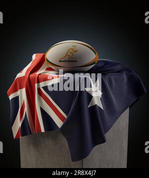 Eine 3D-Darstellung eines generischen Rugby-Balls mit dem Rugby-Logo der Wallabys, das auf einer drapierten australischen Nationalflagge aufliegt - 4. Dezember 2022 in Bristol Stockfoto