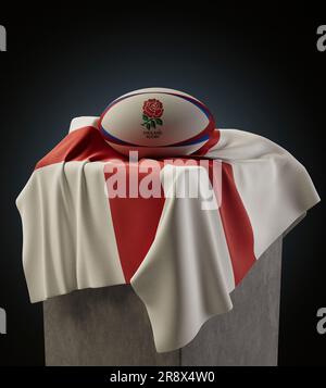 Eine 3D-Darstellung eines generischen Rugby-Balls mit dem Logo von Three Lions Rugby, das auf einer drapierten englischen Nationalflagge aufliegt - 4. Dezember 2022 in Bristol, Stockfoto