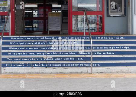 Bahnhof Portsmouth Harbour, Portsmouth, Hampshire, England, Vereinigtes Königreich, Mit Gedicht auf den Stufen Stockfoto