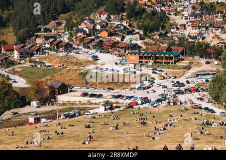 An einem sonnigen Sommerwochenende in Prevalla, einer Bergstadt im Kosovo, entspannen sich die Menschen auf den grasbedeckten Hängen des Prevalla Field Stockfoto