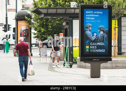 Werbebanner mit Informationen über den bevorstehenden NATO-Gipfel 2023 im Zentrum von Vilnius, der Hauptstadt Litauens, mit Menschen, die zu Fuß unterwegs sind Stockfoto