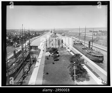 Allgemeine Ansicht der Schlösser, Sault Ste. Marie, zwischen 1890 und 1899. Die Soo Locks auf der St. Marys River ist eine Reihe paralleler Schleusen, die es Schiffen ermöglichen, zwischen Lake Superior und den unteren Großen Seen zu fahren. Das Schiff auf der rechten Seite ist der John W. Moore, hinter dem sich die International Railroad Bridge befindet. Stockfoto