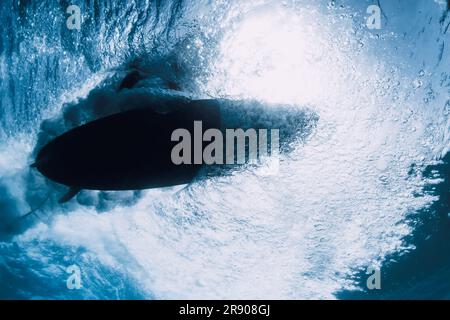 Surfer auf dem Surfbrett mit Blick auf das Meer unter Wasser. Crashing-Welle und Surfbrett Stockfoto