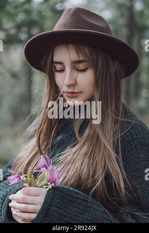 Junge Frau mit langen Haaren und Blumen Stockfoto