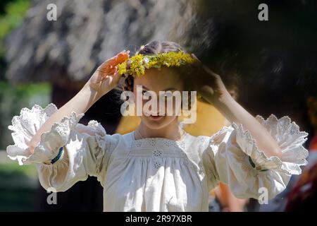 Bukarest, Rumänien. 24. Juni 2023. Ein junges Mädchen, das wie eine Fee gekleidet ist, besucht das traditionelle Volksfest „Sanziene“ in Bukarest, der Hauptstadt Rumäniens, am 24. Juni 2023. Alte Traditionen erwähnen „Sanzienele“ als sanfte Feen, die um die Sommersonnenwende kommen, um Glück und gute Ernte zu bringen. Kredit: Cristian Cristel/Xinhua/Alamy Live News Stockfoto