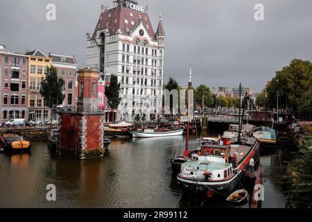 Rotterdam, NL - 6. Oktober 2021: Boote im alten Hafen von Rotterdam, Oude Haven, und das Weiße Haus, Witte Huis Gebäude im Hintergrund bei Regen Stockfoto