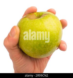 In einer Hand ein grüner Apfel isoliert auf weißem isoliertem Hintergrund Stockfoto
