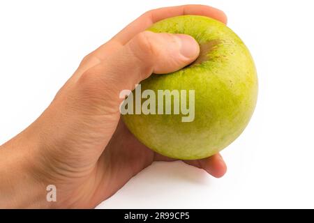 In einer Hand ein grüner Apfel isoliert auf weißem isoliertem Hintergrund Stockfoto