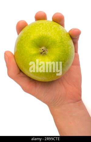 In einer Hand ein grüner Apfel isoliert auf weißem isoliertem Hintergrund Stockfoto