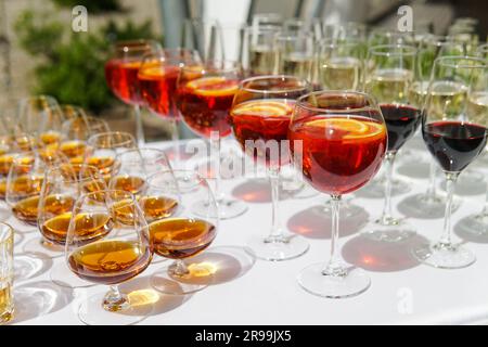 Alkoholische Cocktails in Gläsern auf dem weißen Banketttisch. Stockfoto