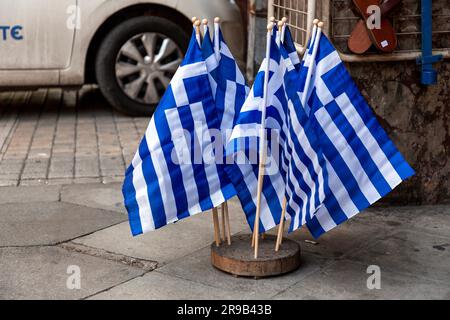 Athen, Griechenland - 25. November 2021: Gruppe kleiner griechischer Flaggen auf der Straße in Athen, Griechenland. Stockfoto