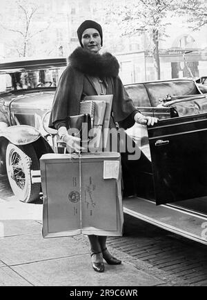 Washington, D.C.: 29. November 1930, Mrs. William Rapley mit ihren Armen voller Weihnachtsgeschenke nach einem Einkaufstag auf der schicken Connecticutt Avenue in der Hauptstadt der Nation. Stockfoto