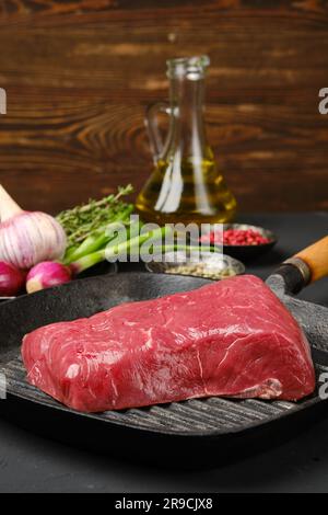 Nahaufnahme eines ungekochten Rindersteaks ohne Knochen auf einer gusseisernen Pfanne Stockfoto
