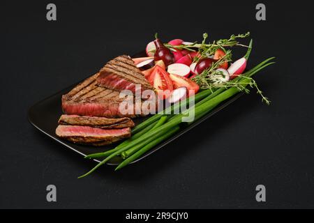 Gegrillte Steaks mit Lenden aus drei Spitzen, Medium, selten auf einem Teller Stockfoto