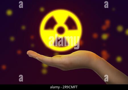 Frau mit leuchtendem Strahlungswarnsymbol auf dunklem Hintergrund, Nahaufnahme Stockfoto