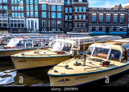 Tourboote, die an der Amstel im Rembrandt Plein in Amsterdam anlegen Stockfoto