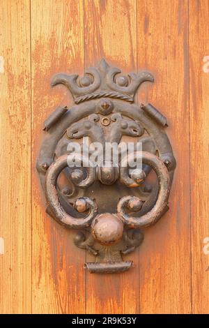 Foto auf der Insel Palma de Mallorca in der Altstadt von Alcudia. Das Bild zeigt einen alten Türgriff aus Metall, fachmännisch ausgeführt. Stockfoto