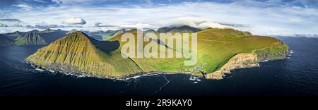 Blick aus der Vogelperspektive auf das Dorf Gjogv von Klippen mit Blick auf den Atlantischen Ozean, die Eysturoy Island und die Färöer Inseln Stockfoto