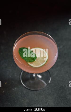Pink Grapefruit Cocktail mit Limettenrad und Minzgarnierung Stockfoto