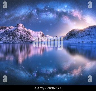 Milchstraße über der Küste und schneebedeckten Bergen Stockfoto