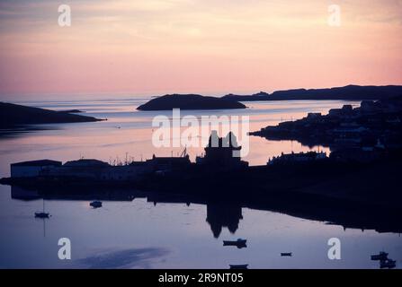 Scalloway, Festland Shetland Islands, Schottland um 1970er. Die Ruine von Scalloway Castle in der Dämmerung, Hafen und kleine Fischerboote im Profil. UK 1970S HOMER SYKES Stockfoto