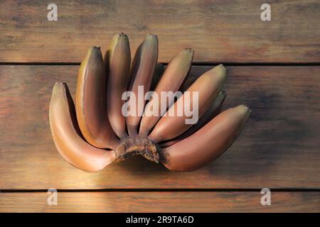 Leckere lila Bananen auf einem Holztisch, Blick von oben Stockfoto