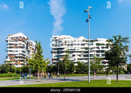 Hadid Residences, houses designed by Zaha Hadid, with park and people walking in foreground, in the stylish CityLife area, Milan, Italy Stock Photo