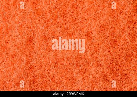 Makroaufnahme einer orange synthetischen Schwamm Textur, Peeling-Seite Stockfoto