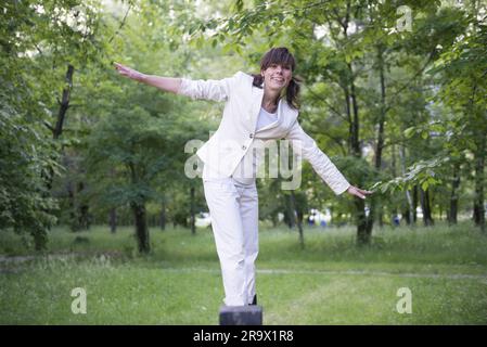 Frau geht auf Holzbalken in der Schweiz Stockfoto