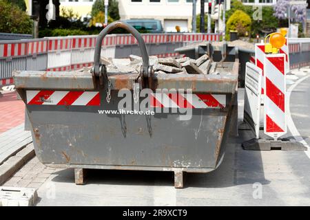 Container, skip für Bauabfälle auf der Straße, Baustelle, Straßenbauarbeiten, Bremen, Deutschland Stockfoto