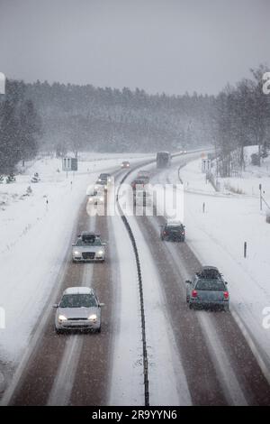 Verkehr auf einer Landstraße bei starkem Schneefall im Winter Stockfoto