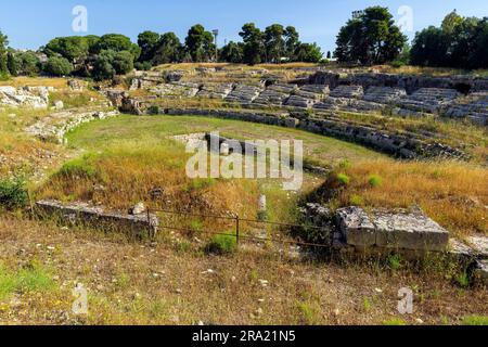 Ruinen des antiken römischen Amphitheaters von 212 v. Chr. im Archäologischen Park von Neapolis in Syrakus, Sizilien, Italien. Stockfoto