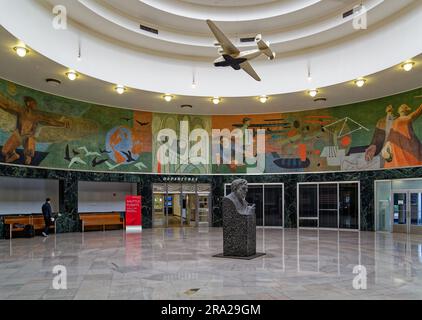 Ein Modell des Pan American Airways System „Yankee Clipper“ ist vom Oberlicht des Marine Air Terminal des Flughafens LaGuardia über dem Wandgemälde „Flight“ aufgehängt. Stockfoto