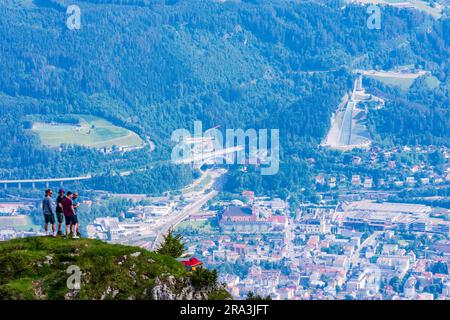 Innsbruck: Blick aus dem Seegrube-Gebiet auf die Nordkette (Inntalkette) bis zur Stadt Innsbruck, Wanderer, Bergisel-Skisprungschanze in der Region Innsbruck, Stockfoto