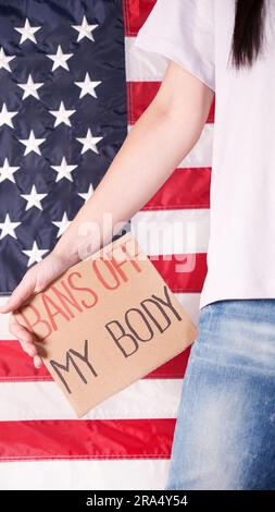 Frau mit einem Schild verbietet My Body amerikanische Flagge auf dem Hintergrund. Protest gegen Abtreibungsverbot. Frauenstreik. Frauen Rechte Freiheit Stockfoto