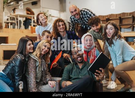 Glückliches, gealtertes, multiethnisches Business-Team, das im Büro ein Selfie macht Stockfoto