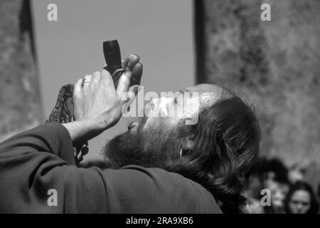 SID Rawle, auch bekannt als König der Hippies, raucht eine „Friedenspfeife“. Stonehenge Free Festival bei der Sommersonnenwende, Wiltshire, England, Juni 21. 1979. 1970S GB HOMER SYKES Stockfoto