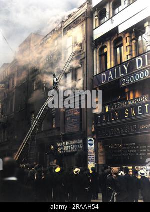 Die Feuerwehr reagiert auf einen Gebäudebrand neben den Büros von Daily Sketch in Manchester (C. Walter und Co.) Eine Notleiter mit Rädern war am oberen rechten Fenster angebracht, wo zwei Personen zu sehen sind, die versuchen, durch den Rauch aus dem Gebäude zu fliehen. Stockfoto