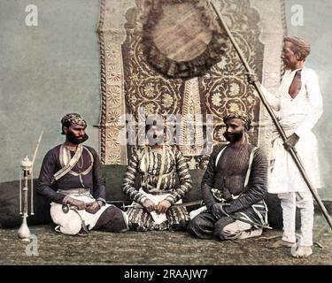 Drei Jat Sirdars (Sikh-Führer) mit Aufseher, Indien. Datum: Ca. 1890er Stockfoto