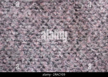 Hintergrundstruktur aus grauem, pinkbeigefarbenem Strickmaterial aus Baumwolle oder Wolle. Stockfoto