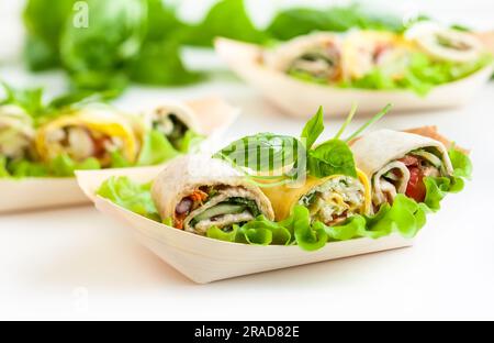 Auswahl an frischen Tortilla-Wraps mit Huhn, Käse und Gemüse. Gesundes Fast Food Stockfoto