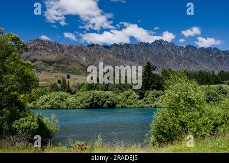 Die berühmten Remarkables Mountains ragen über den Kawarau River, der nördlich von Queenstown auf Neuseeland South Island verläuft. Foto: Rob Watkins Stockfoto