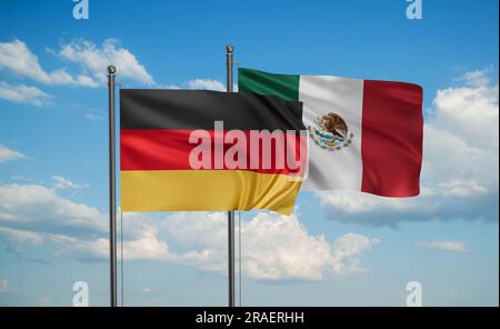 Die mexikanische Flagge und die deutsche Flagge, die zusammen auf blauem Himmel schweben, das Konzept der Zusammenarbeit zwischen zwei Ländern Stockfoto