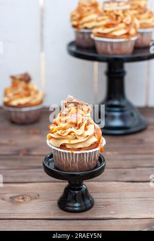 Erdnussbutter-Cupcakes mit gesalzenem Karamell, Toffee und Schokoladenbissen Stockfoto