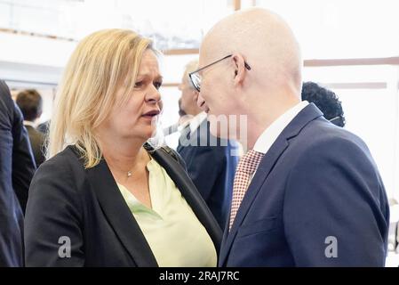 Karlsruhe, Deutschland. 04. Juli 2023. Nancy Faeser (SPD), Bundesministerin des Innern, und Peter Tschentscher (SPD), Präsident des Bundesrats, begrüßen einander im Anhörungssaal. In der mündlichen Verhandlung vor dem Bundesverfassungsgericht wird die Frage untersucht, ob die NPD von der Finanzierung durch die Staatsparteien ausgeschlossen werden kann. Kredit: Uwe Anspach/dpa/Alamy Live News Stockfoto