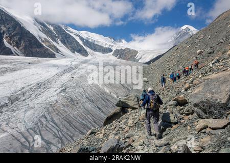 Eine Gruppe von Touristen steigt einen Gletscher im Altai-Gebirge hinauf. Aktru am Sommertag. Stockfoto