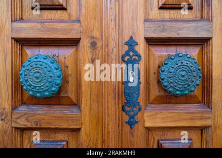 Dekorative dekorative bronzene Türknöpfe an geschlossenen Türen. Stockfoto