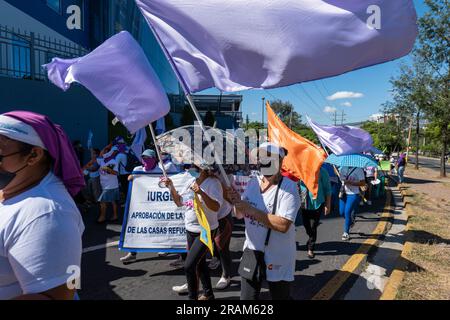 Tegucigalpa, Francisco Morazan, Honduras - 25. November 2022: Mehrere Frauen mit Flaggen marschieren zum Internationalen Tag zur Beseitigung von Gewalt Stockfoto