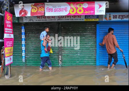 Bei starkem Regen machen sich die Leute auf den Weg. Die unaufhörlichen Regenfälle der letzten Tage haben in Sylhet zu Problemen mit der Wassergewinnung geführt, wobei viele Straßen unter Wasser waren. Aufgrund ungeplanter Baumaßnahmen und eines schlechten Abflusssystems werden diese wasserdurchlässigen Bereiche bei starken Regenfällen und sogar leichten Regenfällen überflutet, so die Einheimischen. Sylhet, Bangladesch. Stockfoto